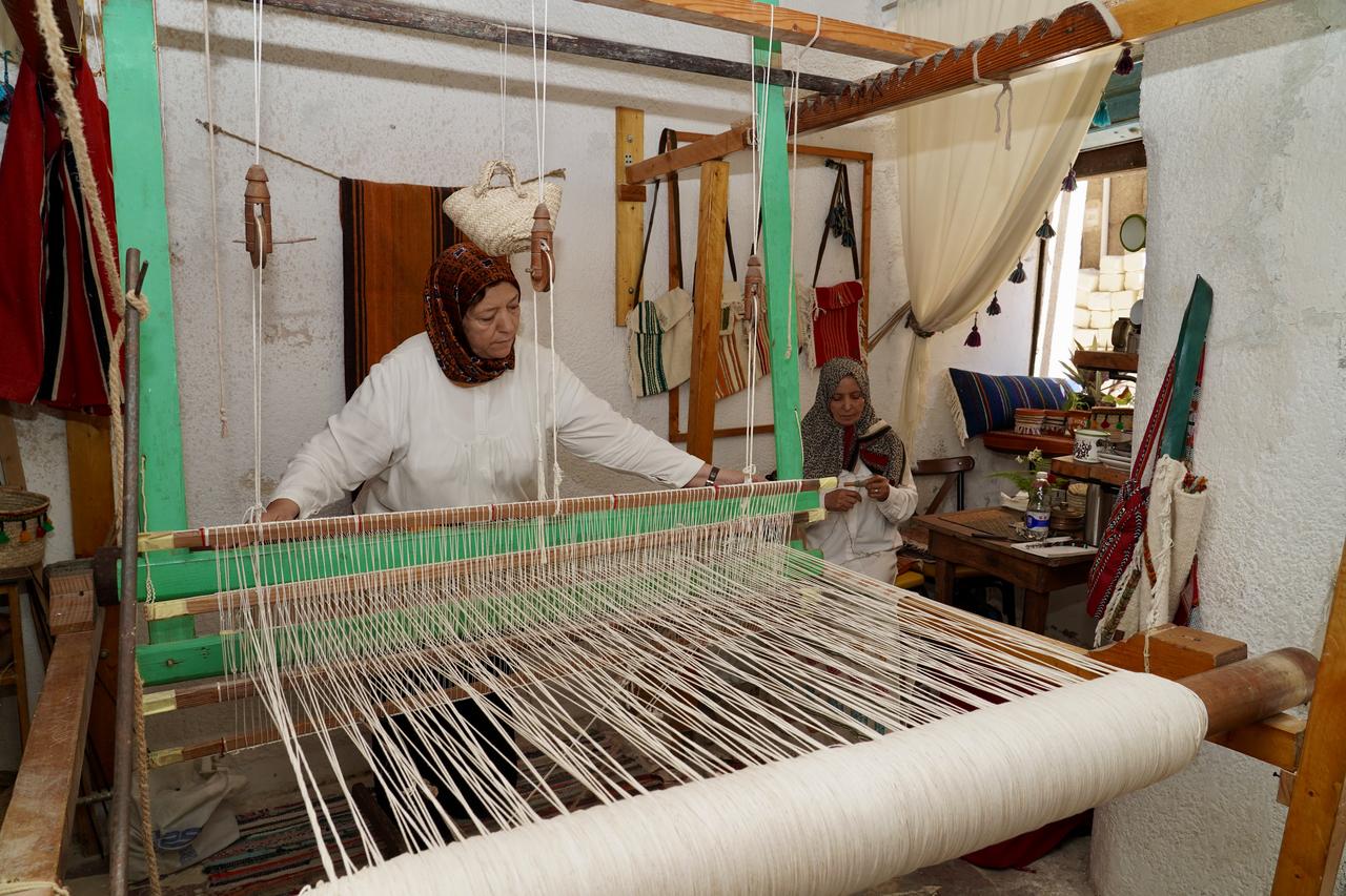 Libyan cousins Zeynep Madi (L) and Ayse Madi (R) work to revive the historic craft of traditional weaving using a century-old loom at their workshop in the Old City of Tripoli, Libya on October 06, 2026. (AA Photo)