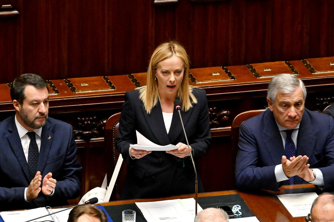 Italy’s new Prime Minister Giorgia Meloni (C)  speaks in her first address to parliament, next to her Deputy and Foreign Minister, Antonio Tajani (R) and her Deputy and Minister of Infrastructure, Matteo Salvini (L) ahead of a confidence vote at Montecitirio palace in Rome on October 25, 2022. (AFP File Photo)