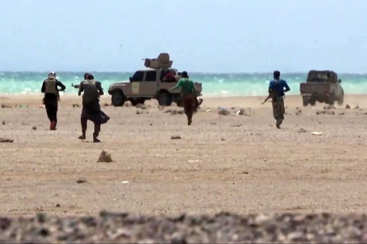 This screen grab taken from video footage released by the pro-Yemeni government Southern Giants Brigades on October 6, 2026 reportedly shows fighters near the Red Sea shore in the Dhobab district in Taiz province. (AFP Photo/Yemen Giants Brigades Media Centre/Handout)