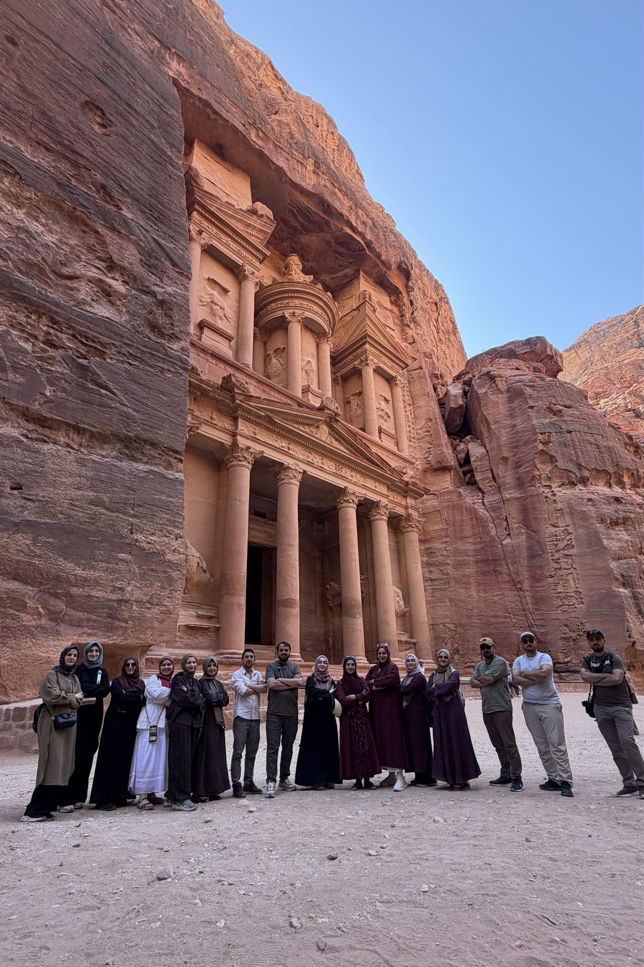 Pilgrims traveling from Türkiye to Saudi Arabia by road pose in front of Al-Khazneh (the Treasury), the ancient rock-carved monument in Petra, Jordan. (AA Photo)