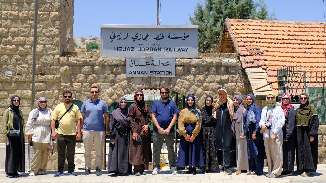 A group of pilgrims from Türkiye poses in front of the historic Hejaz Railway's Amman Station in Jordan during their overland Umrah journey to Saudi Arabia. (AA Photo)
