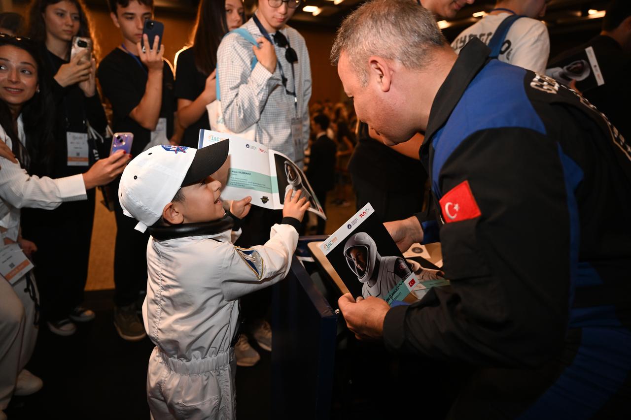 Astronauts from various countries meet visitors during an autograph session on Public Day of the 77th International Astronautical Congress (IAC 2026) at the NEST Congress Center in Antalya, Türkiye, on Oct. 9, 2026. (AA Photo)