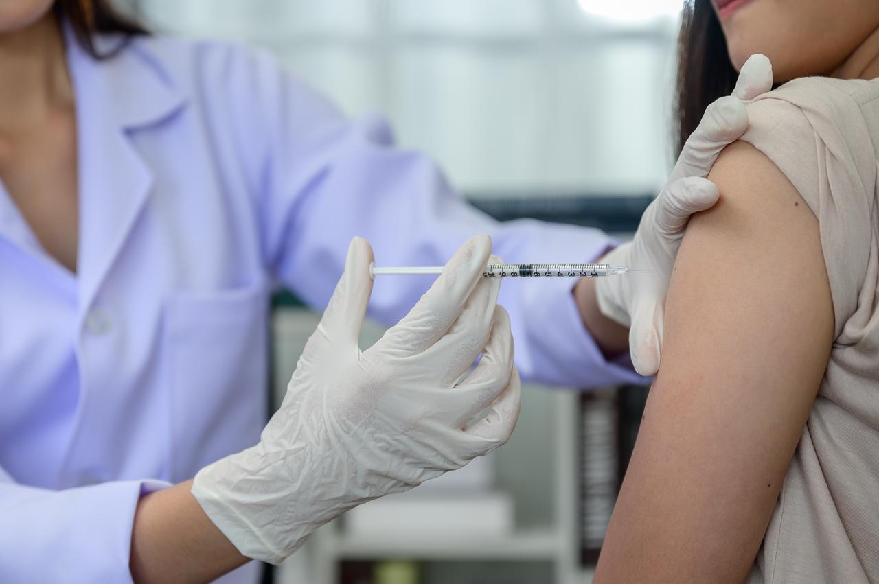 A health care worker administers an injection to a patient. (Adobe Stock Photo)