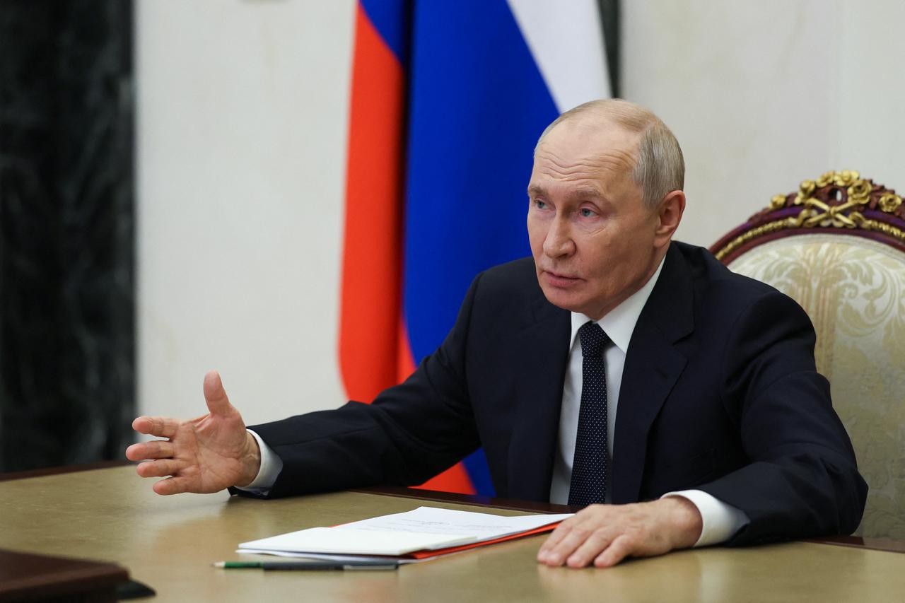 In this pool photograph distributed by the Russian state agency Sputnik, Russia's President Vladimir Putin chairs a Security Council meeting via videolink in Moscow on Oct. 7, 2026. (Photo by Sputnik / AFP)