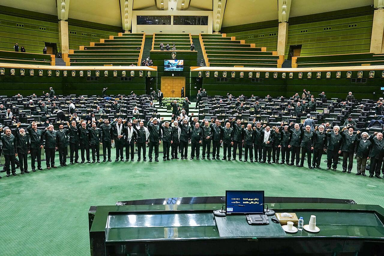 In this handout picture provided by Ithe Islamic Consultative Assembly News Agency (ICANA), members of Iran's parliament dressed in IRGC uniforms, chant "Death to America" during a session in Tehran on February 1, 2026. (AFP Photo / ICANA HO)