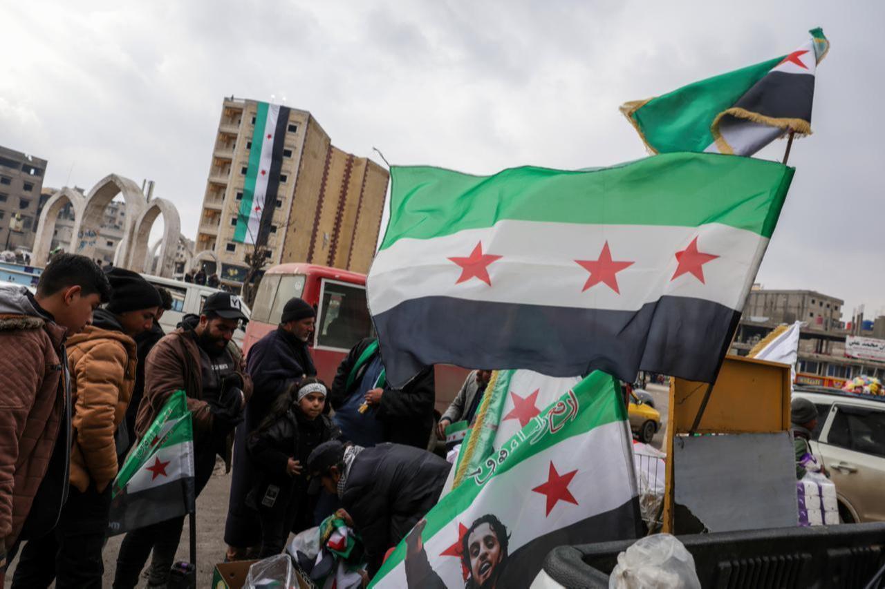 A three-star Syrian flag is seen for sale on the streets and in shops in Raqqa, Syria, on Jan. 28, 2026. (AA Photo)