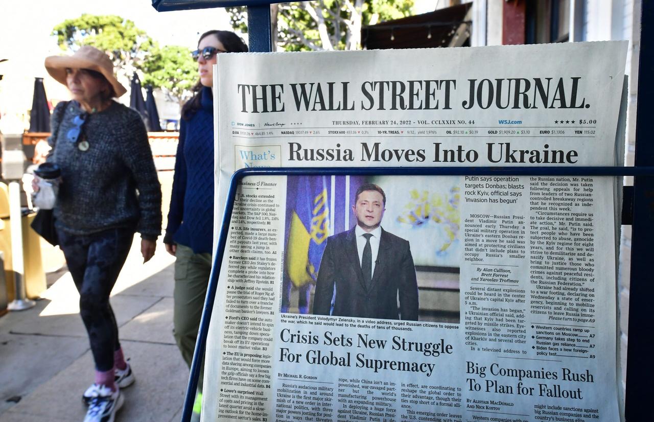 Pedestrians walk past a newspaper stand with copies of The Wall Street Journal and a front page report on Russia's invasion of Ukraine are being sold on February 24, 2022 in Los Angeles, California. (AFP Photo)