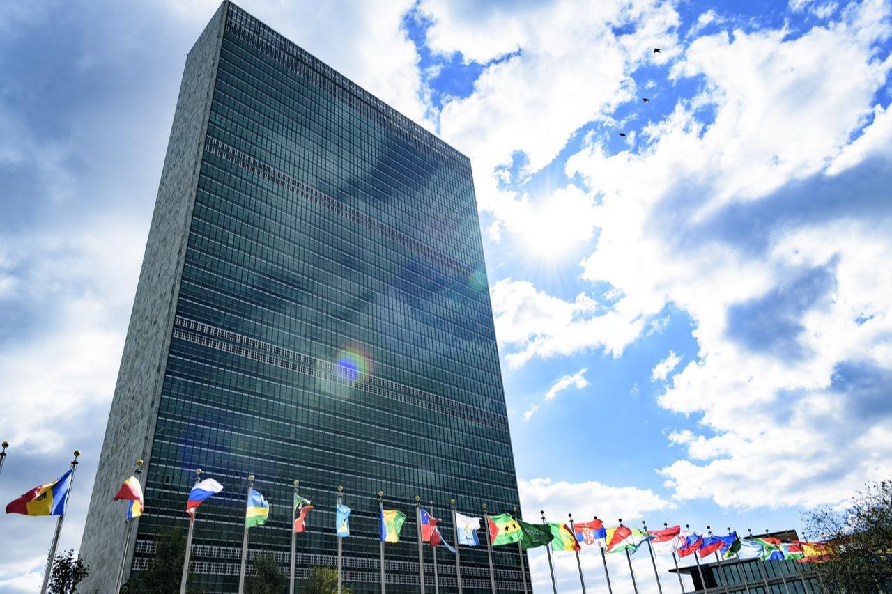 A view of the Secretariat building with flags of Member States in the foreground, at UN Headquarters. (UN Photo)