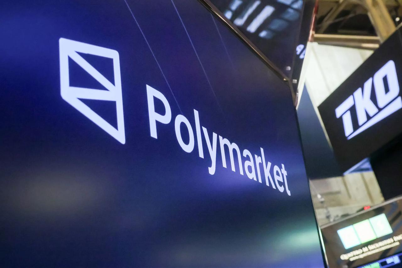Polymarket logo displayed on a screen at a crypto and fintech industry event booth. (AFP Photo)
