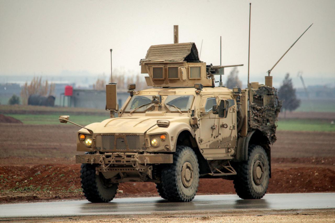 A US military mine-resistant ambush protected (MRAP) vehicle moves along a road in a convoy transporting Daesh detainees on the outskirts of Qahtaniyah in Hasakah, Syria, Feb. 7, 2026. (AFP Photo)