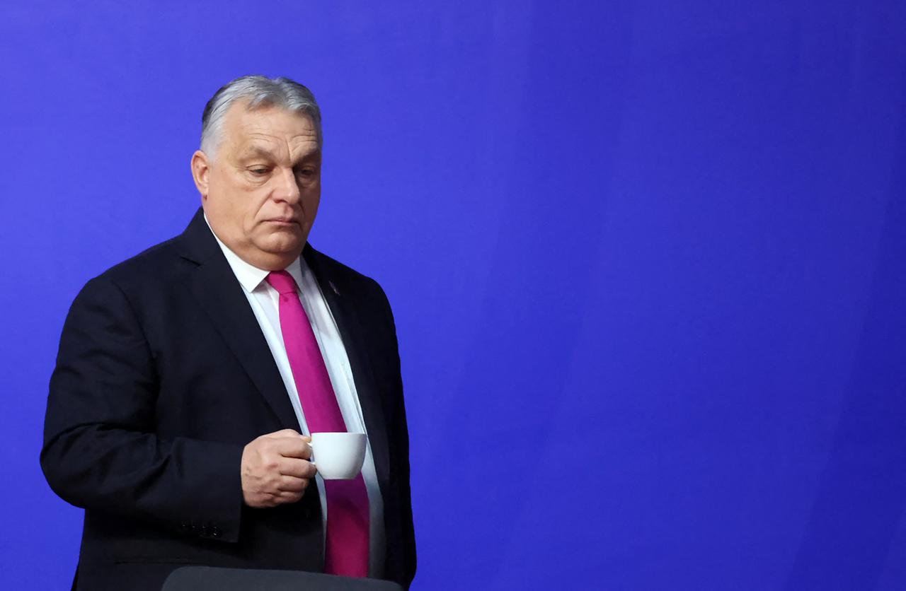 Hungary's Prime Minister Viktor Orban carries a beverage as he takes part in the Informal EU Leaders' Retreat at the Alden Biesen Castle in Alden Biesen, central Belgium on February 12, 2026. (AFP Photo)