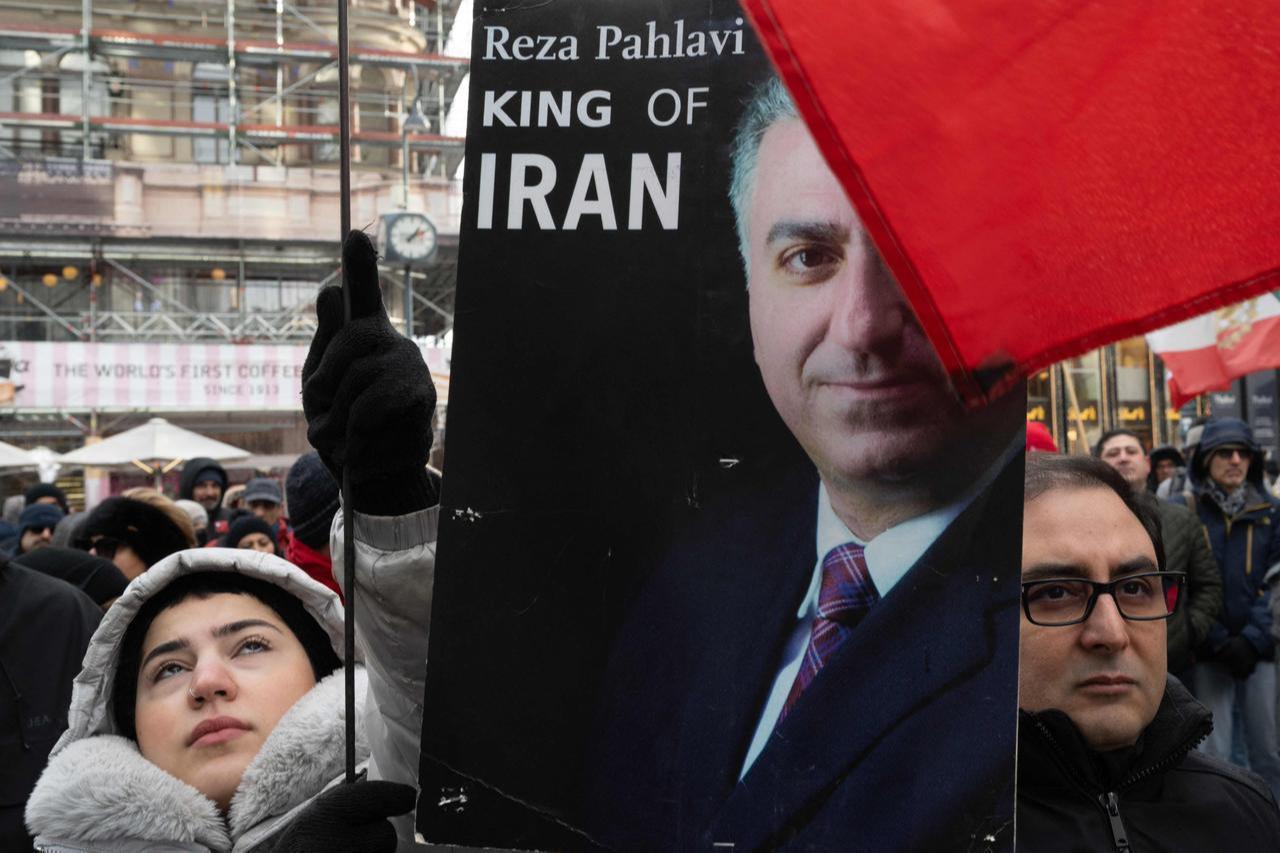 Protesters hold up a placard featuring Reza Pahlavi, an Iranian dissident in exile in the United States and son of the last shah of Iran, during a demonstration in Vienna, Austria on Jan. 11, 2026. (AFP Photo)