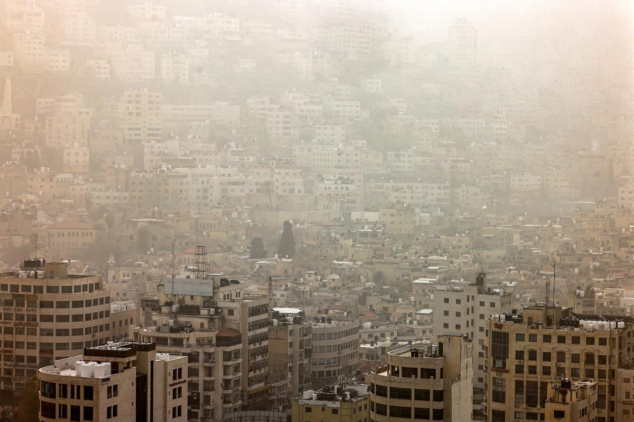 A dust storm engulfs the city of Nablus in the occupied West Bank on February 14, 2026. (AFP Photo)