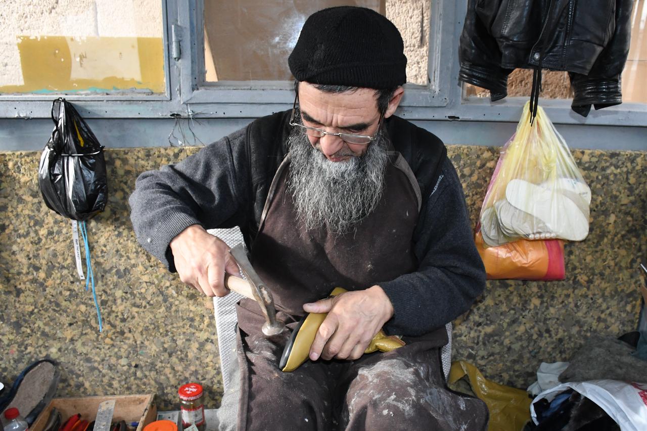 A Kyrgyz leather artisan works by hand on traditional footwear in Yenifakili district of Yozgat, central Türkiye, Feb. 15, 2026. (IHA Photo)