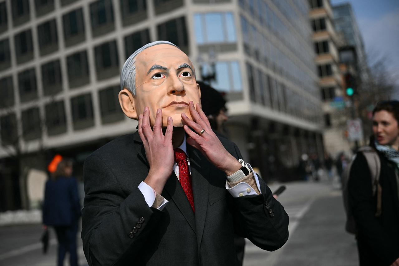 A person wearing a mask impersonating Israel Prime Minister Benjamin Netanyahu protest near the White House against the visit to the US of Netanyahu in Washington, DC, Feb. 11, 2026. (AFP Photo)