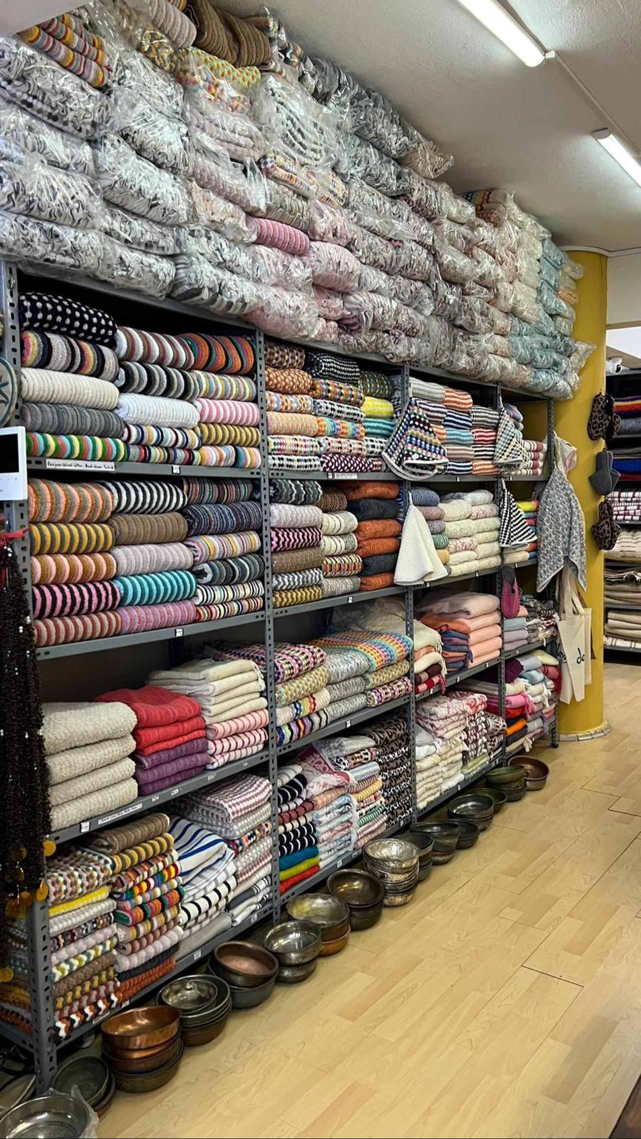 Interior of Dervis Store showing folded towels in various colors and designs on shelves. (Nour Dajani/Türkiye Today)