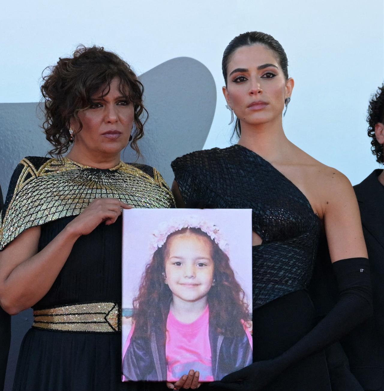 US actor Joaquin Phoenix, US actress Rooney Mara, Tunisian director Kaouther Ben Hania, actor Motaz Malhees, and actress Clara Khoury pose with a portrait of late Palestinian girl Hind Rajab during the red carpet for the movie The Voice of Hind Rajab at the Venice Film Festival, at Venice Lido on September 3, 2025. (AFP photo)