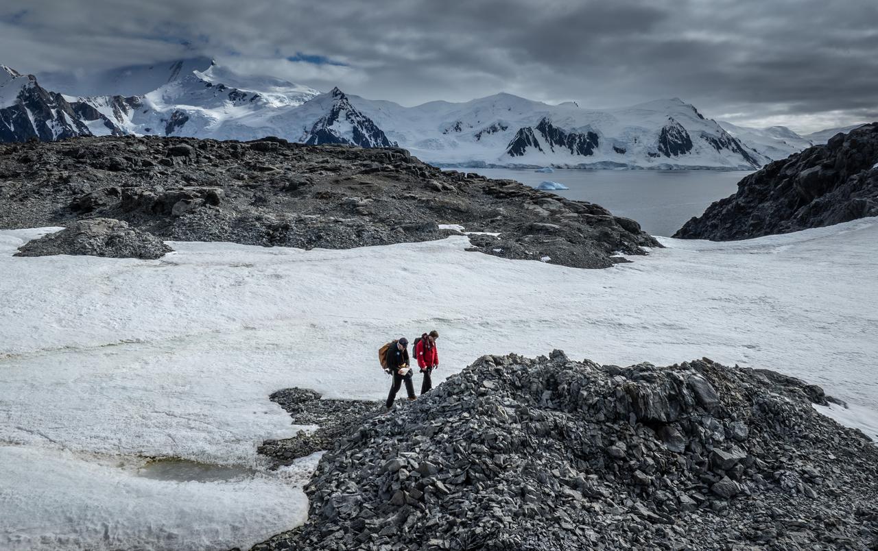 Researchers walk across a rocky and glacial landscape on Horseshoe Island while carrying out geological surveys aimed at understanding Antarctica’s deep past. (AA Photo)