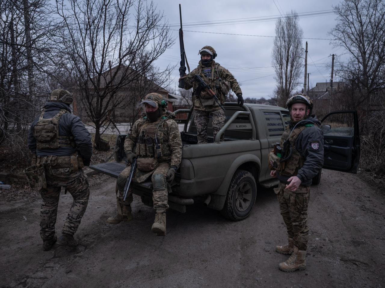 Ukrainian soldiers standing near a pickup truck before assignments on the frontline, at an undisclosed location near Kostyantynivka, Donetsk region. (Photo by Handout/The 93rd Kholodnyi Yar Separate Mechanized Brigade/AFP)