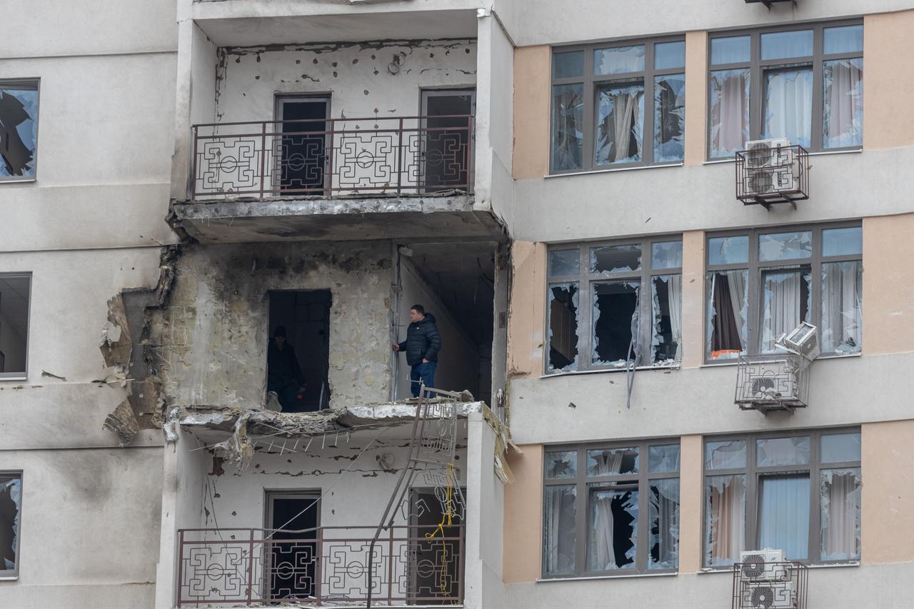 A resident stands into a damaged residential building at the site of a Russian attack in Odesa, Ukraine on February 17, 2026. (AFP Photo)