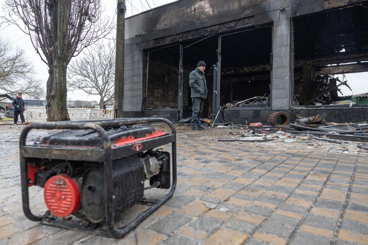 A resident stands next to a damaged grocery store building at the site of a Russian attack in Odesa, Ukraine on February 17, 2026. (AFP Photo)