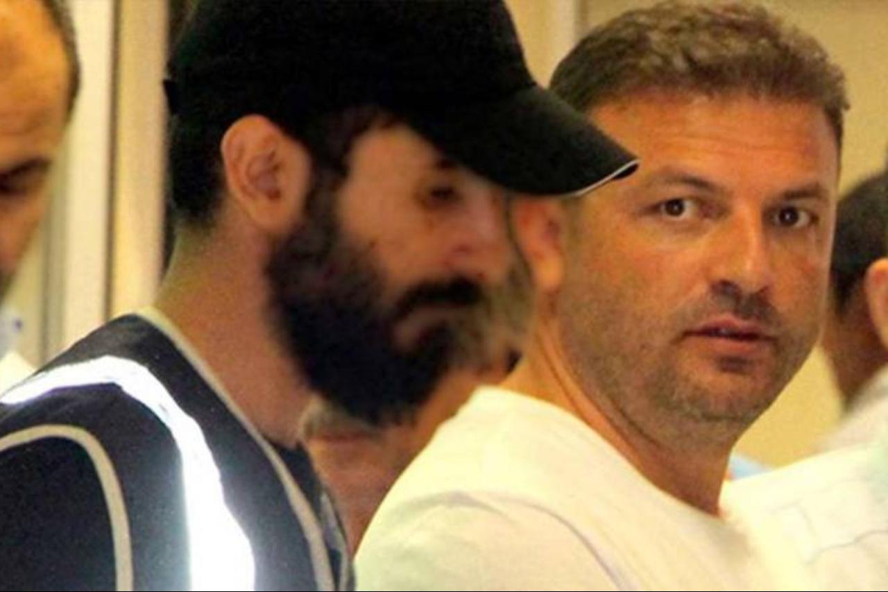 Photo shows Veysel Sahin escorted by Turkish police officers.  (Photo via T24)