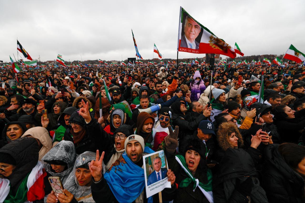 Hundreds of demonstrators attend a demonstration of the Iranian opposition and hold a flag with the portrait of Iran's former crown prince and now key opposition figure Reza Pahlavi on February 14, 2026 at the Theresienwiese fair grounds in Munich, southern Germany. (AFP Photo)