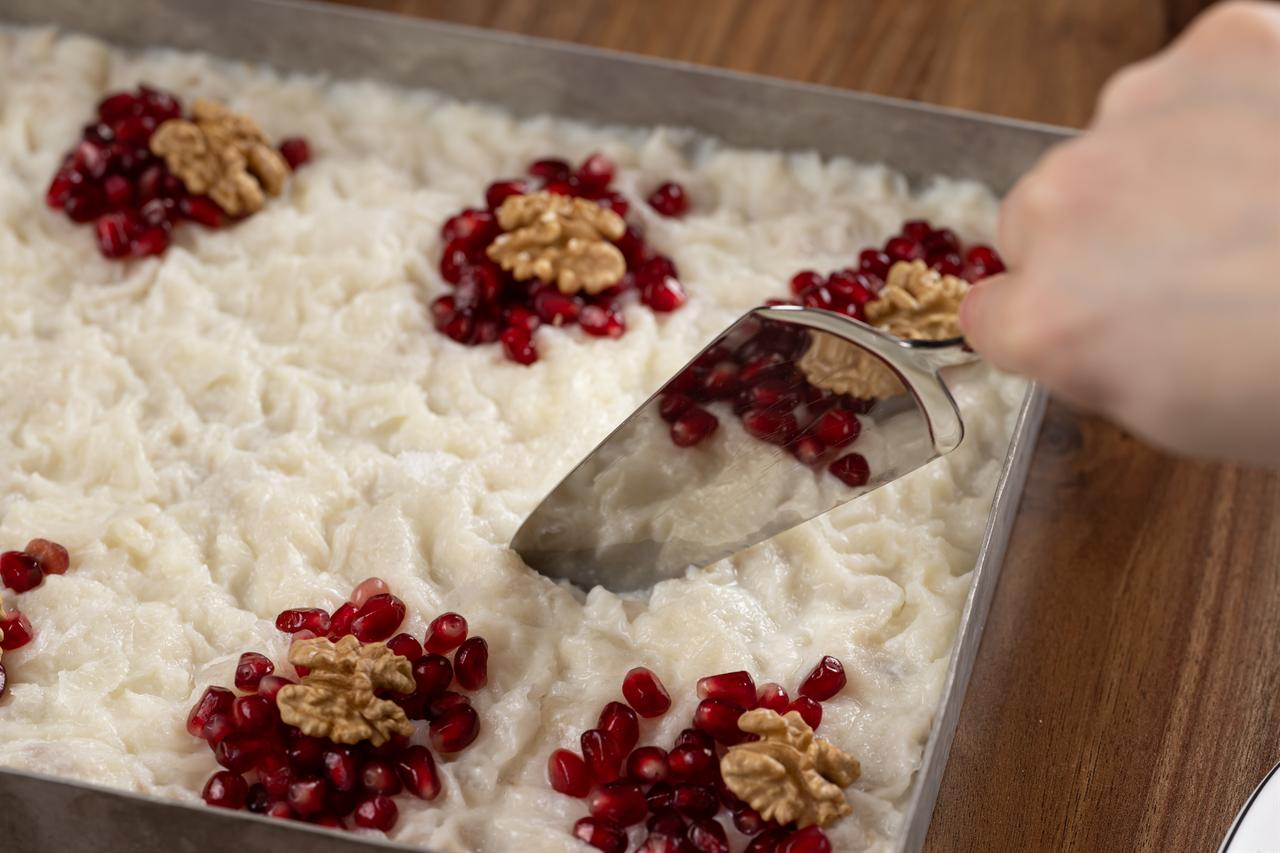 Gullac, one of the most beloved desserts of the holy month of Ramadan for Muslims, decorated with walnuts and pomegranate seeds, is seen in Ankara, Türkiye, Feb. 17, 2026. (AA Photo)