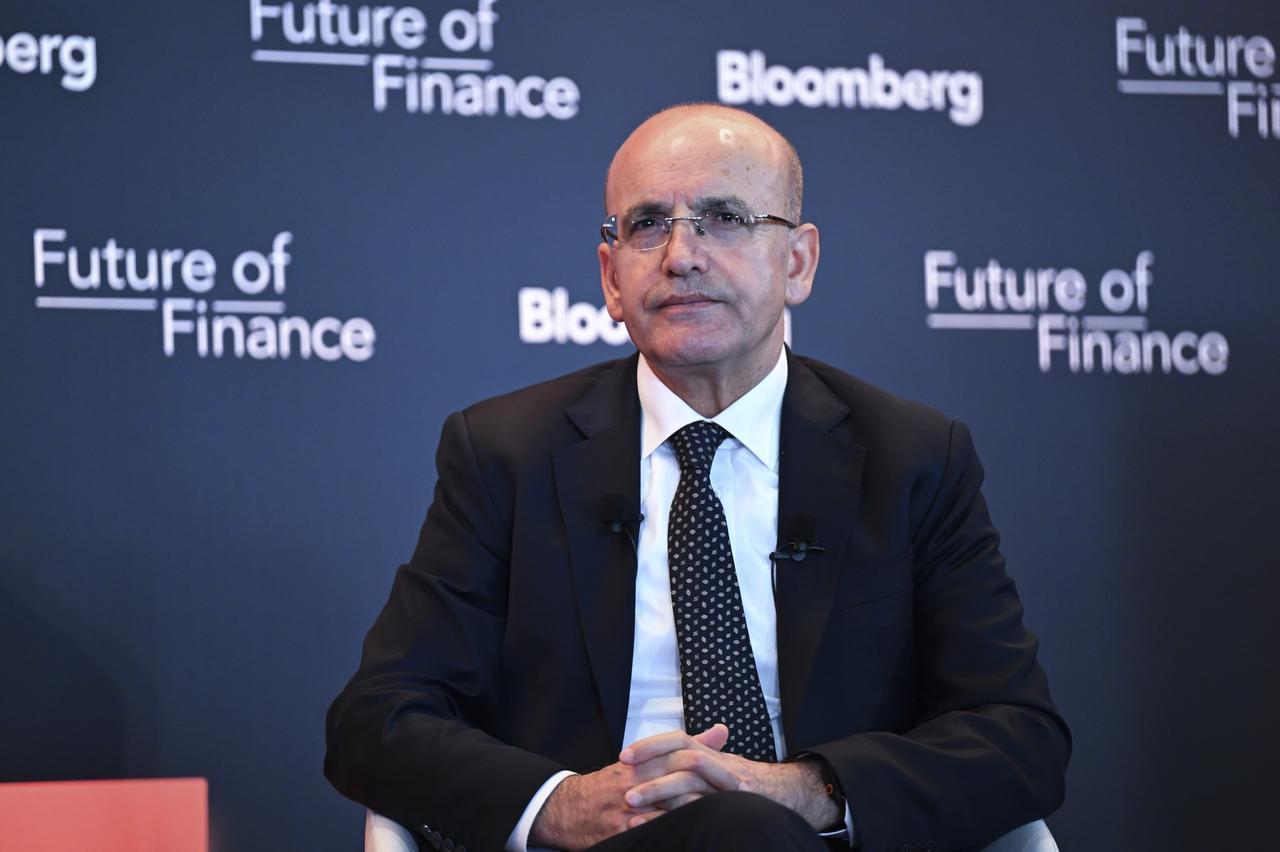Turkish Treasury and Finance Minister Mehmet Simsek (right) answers questions at the "Future of Finance" event organized by Bloomberg in Istanbul, Türkiye, on Feb. 4, 2025. (AA Photo)