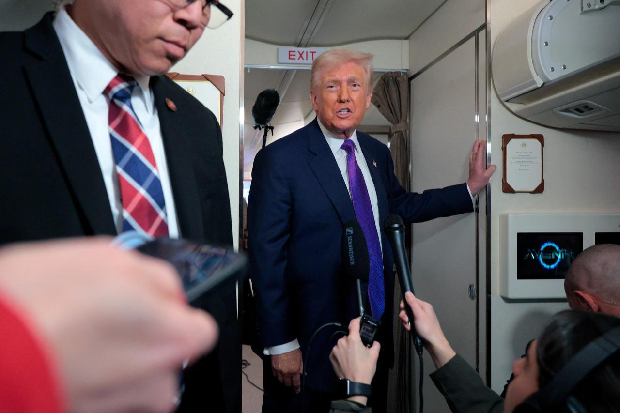 US President Donald Trump speaks to the media on Air Force One on February 19, 2026, at Joint Base Andrews, Maryland. (AFP Photo)