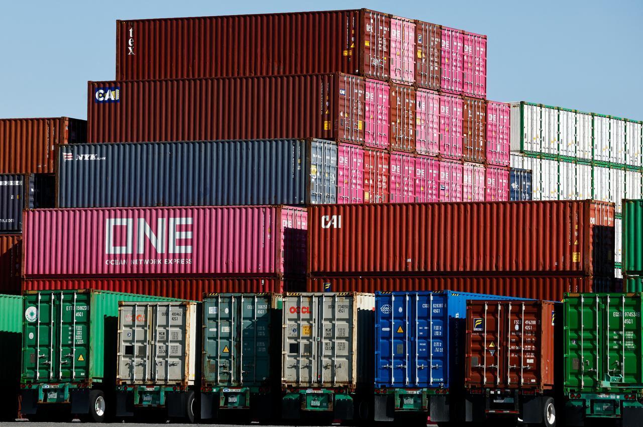 Shipping containers stand stacked while others rest on truck transport chassis at the Port of Los Angeles on February 20, 2026, in Los Angeles, California. (AFP Photo)