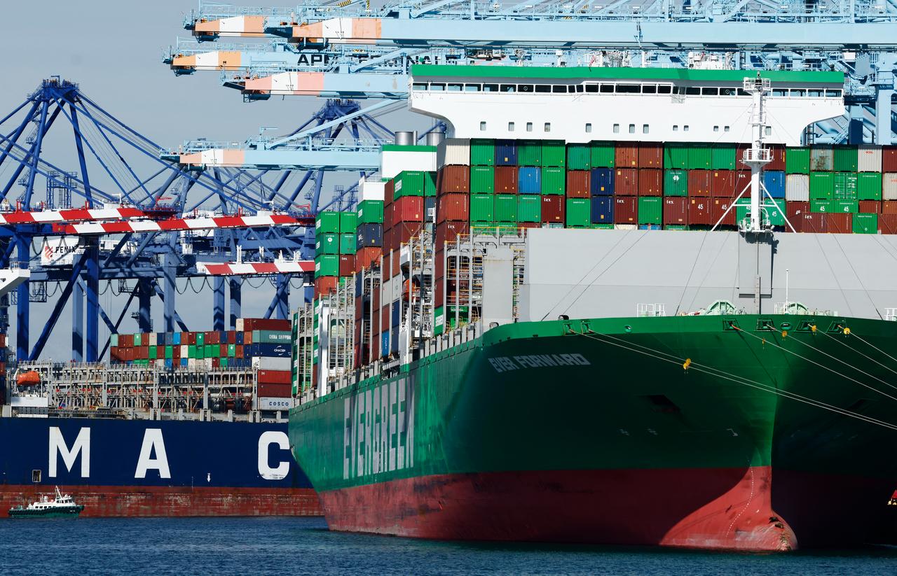Shipping cranes stand above container ships loaded with shipping containers at the Port of Los Angeles on February 20, 2026, in Los Angeles, California. (AFP Photo)