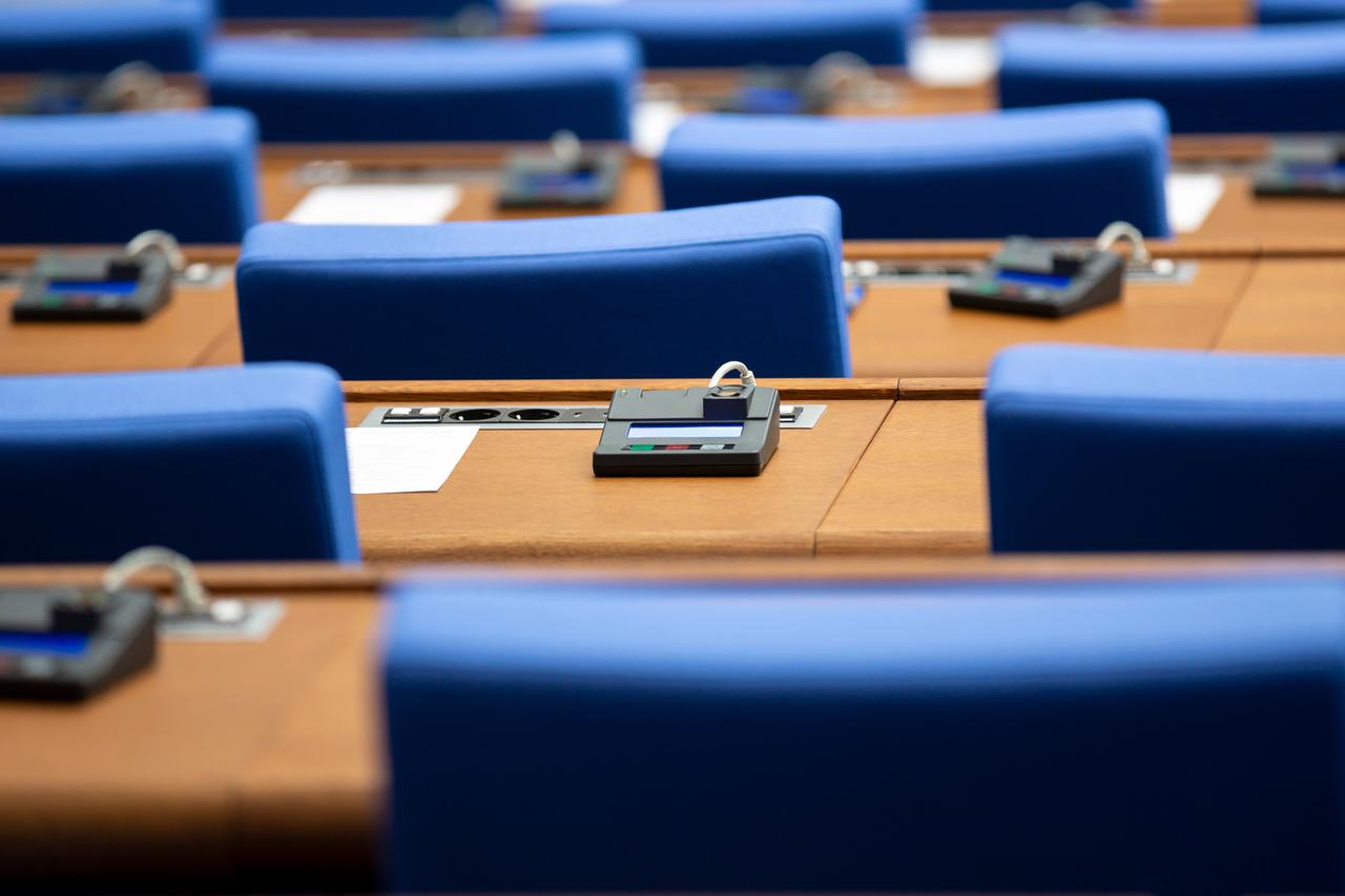 Seats and electronic voting devices are seen inside the European Parliament chamber in Strasbourg, France. (Adobe Stock Photo)