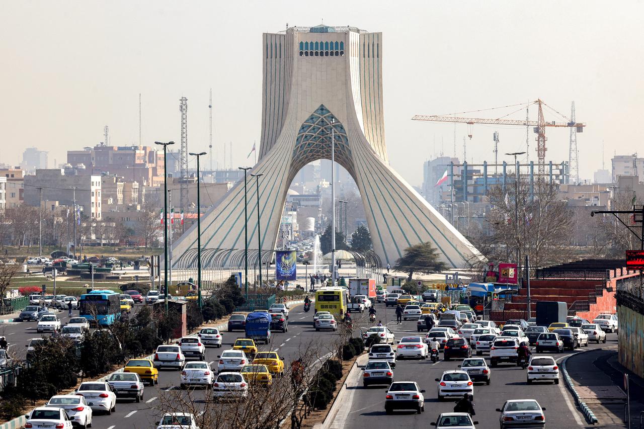 Vehicles move along a highway near Tehran's landmark Azadi (Freedom) Tower in Tehran on February 23, 2026. (AFP Photo)