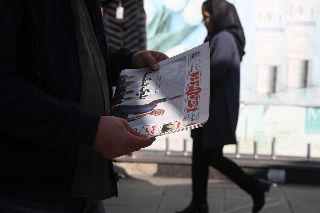 A man reads a newspaper as second round of indirect negotiations between Iran and the US in Geneva is widely covered in Iranian newspapers, Feb. 17, 2026 in Tehran, Iran. (AA Photo)