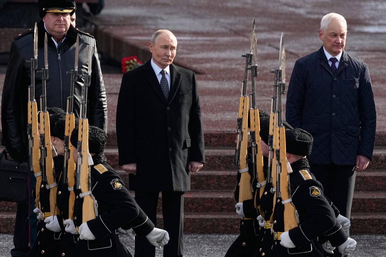 Russia's President Vladimir Putin (C) and Russia's Defence Minister Andrei Belousov (R) attend a wreath-laying ceremony at the Tomb of the Unknown Soldier by the Kremlin Wall to mark Defender of the Fatherland Day in Moscow, Russia on February 23, 2026. (AFP Photo)