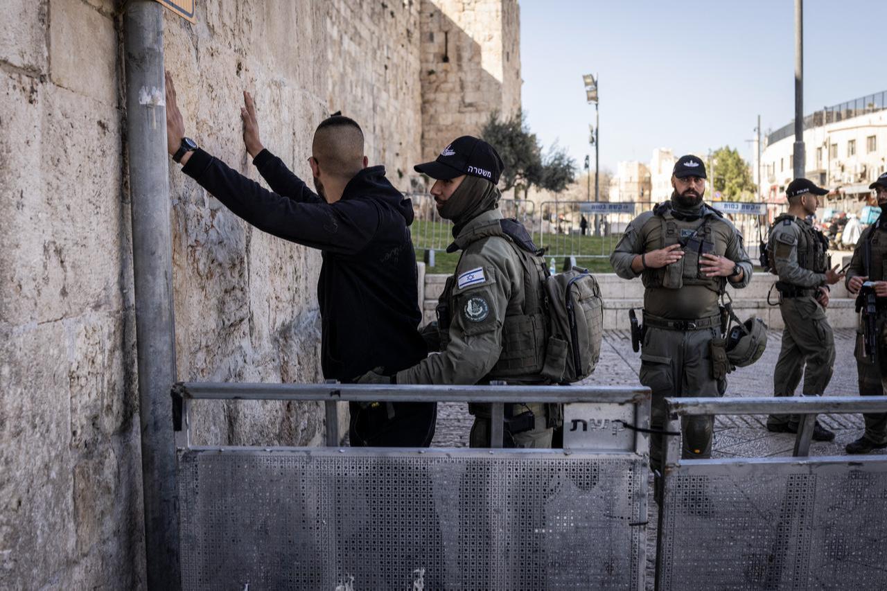 An Israeli borderguard searches a Palestinian man before the first Friday noon prayers of the holy month of Ramadan in the old city of Jerusalem on February 20, 2026. (AFP Photo)