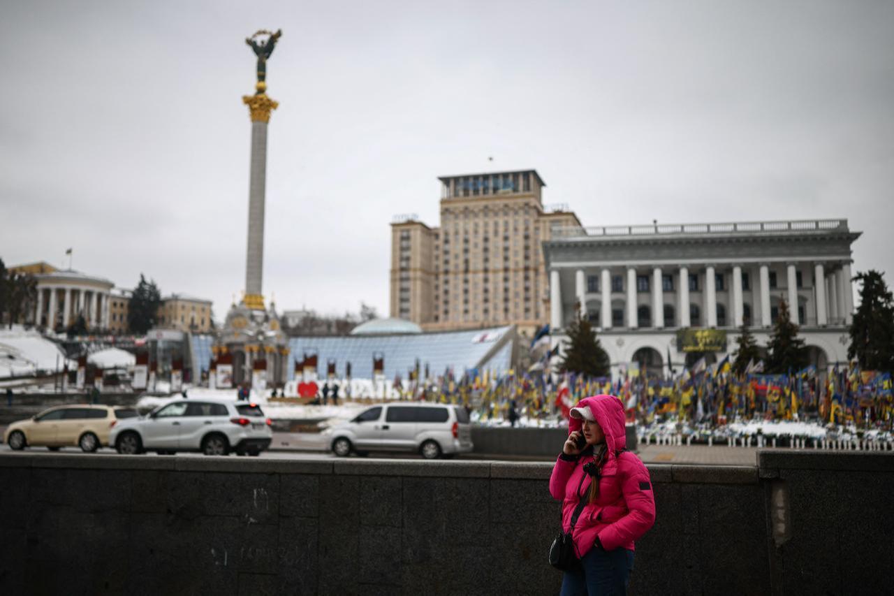 A person stands at a metro entrance in Independence Square in Kyiv on February 23, 2026, as the conflict with Russia reaches its four-year mark. (AFP Photo)