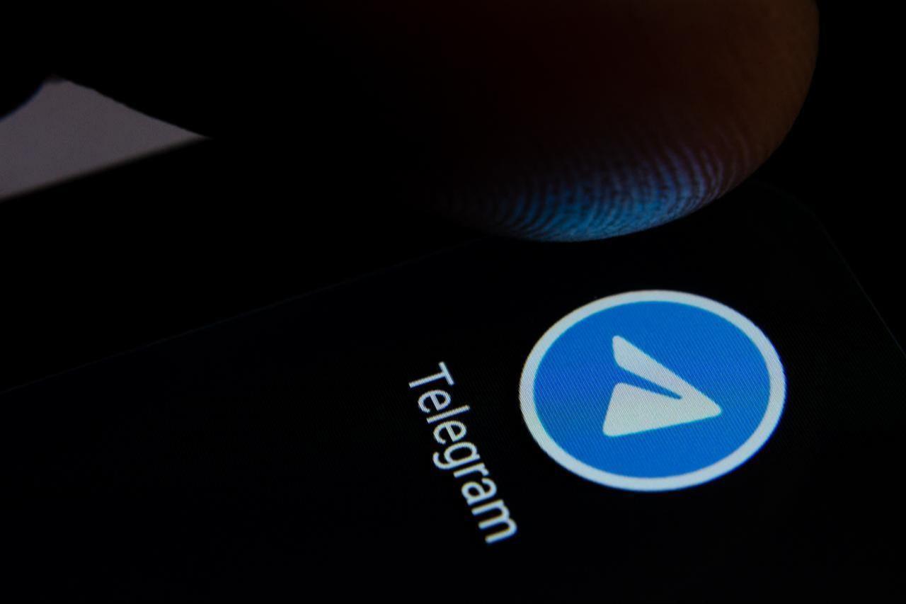 Telegram app icon on the smartphone screen with visible pixels and the finger about to launch it in the United Kingdom, July 28, 2019. (Adobe Stock Photo)