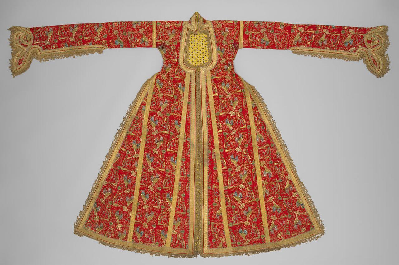Three-skirt Ottoman entari, late 19th century. Red wool twill with turquoise lining, split-palmette cuffs, and gilt-thread hüseyni embroidery. Worn by middle and upper-class women for special occasions, featuring a fitted waist, widening skirt, and Balkan-influenced details. (source: metmuseum)