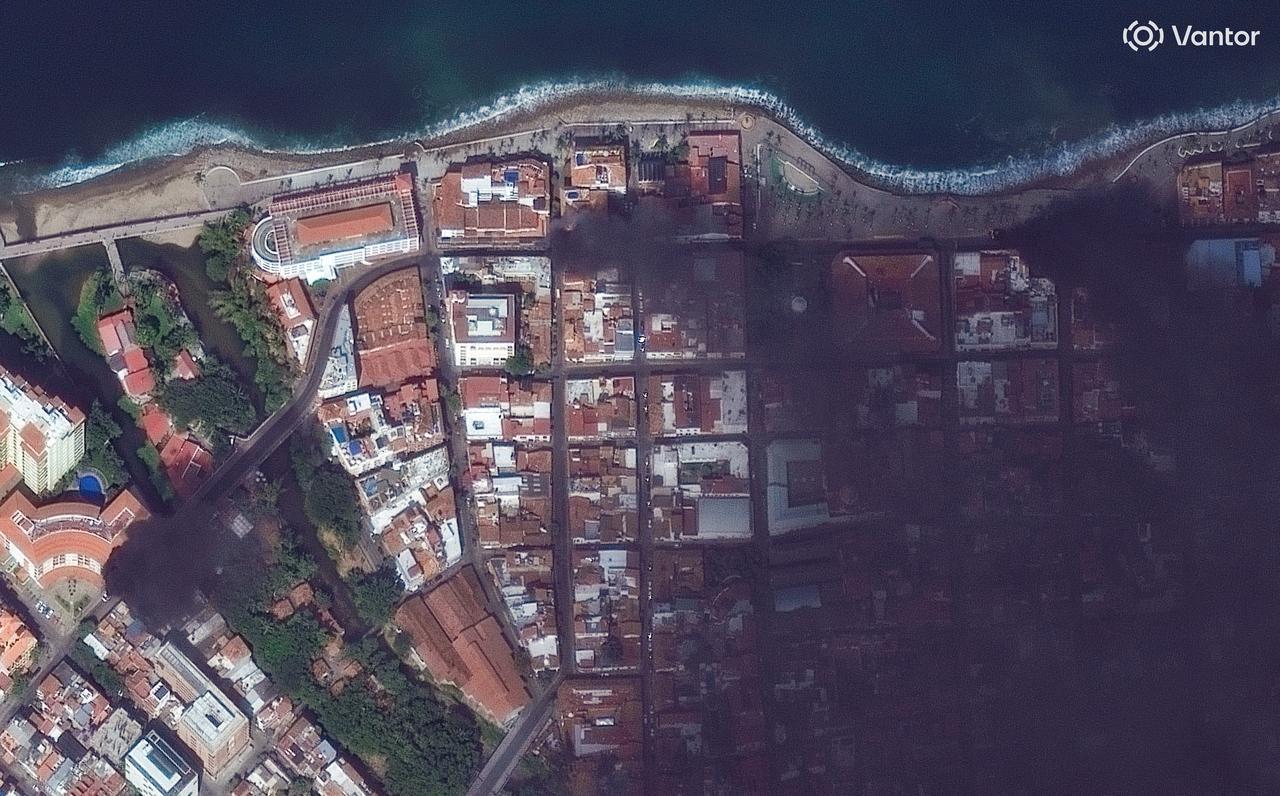 Handout photo released by Satellite image ©2026 Vantor on February 22, 2026, shows fires and roadblocks on the streets of Puerto Vallarta, Mexico. (Photo by Handout/Imagen satelital ©2026 Vantor/AFP)