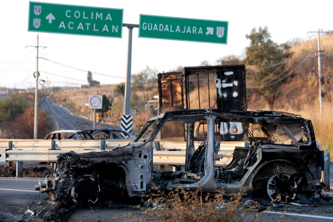 A burned car is seen on a highway near Acatlan de Juarez, Jalisco state, Mexico, Feb. 22, 2026. (AFP Photo)