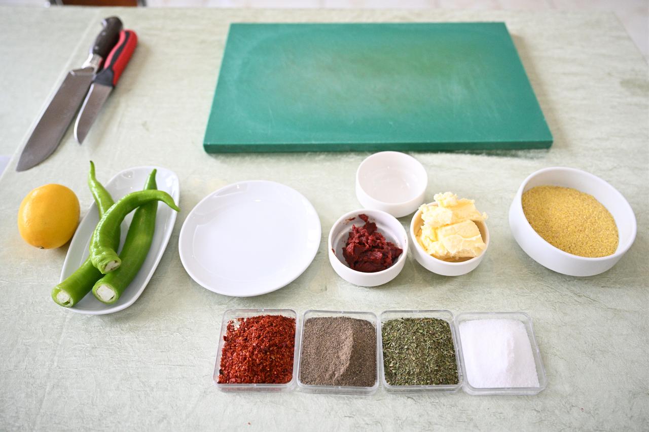 Ingredients used in Kayseri’s traditional wedding soup, including fine bulgur, peppers, butter and spices, are displayed before preparation in Kayseri, Türkiye, Feb. 24, 2026. (AA Photo)
