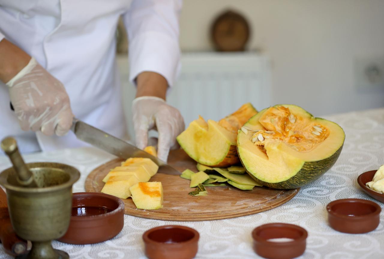 Winter squash is chopped and prepared as the main ingredient of tikvenik pastry, a Balkan-origin dish featured in Kirklareli cuisine, in Kirklareli, Türkiye, Feb. 25, 2026. (AA Photo)