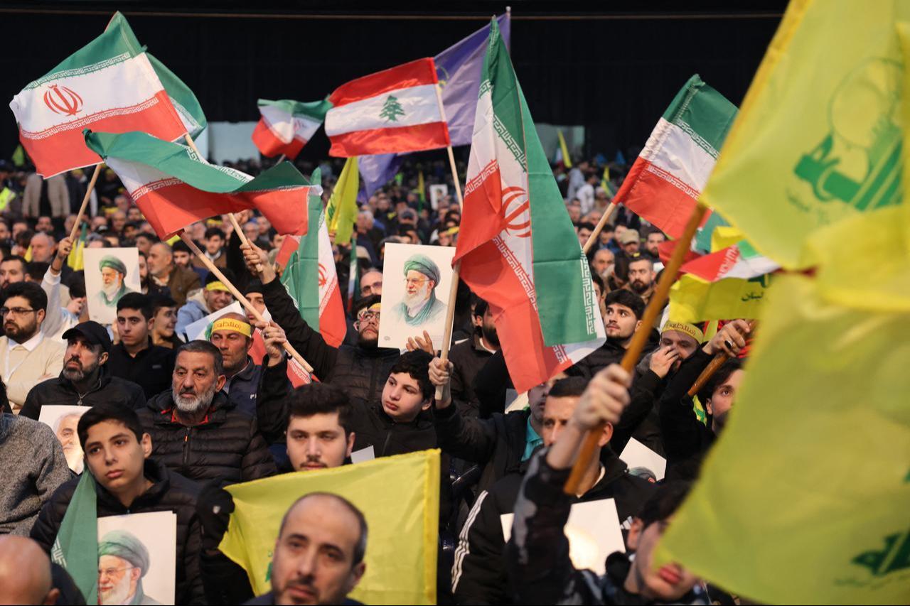 Hezbollah supporters wave Iranian and Lebanese flags while holding portraits of Iran's Supreme Leader Ayatollah Ali Khamenei during a rally to show their solidarity with Iran, in the southern suburb of Beirut, Lebanon on January 26, 2026. (AFP Photo)