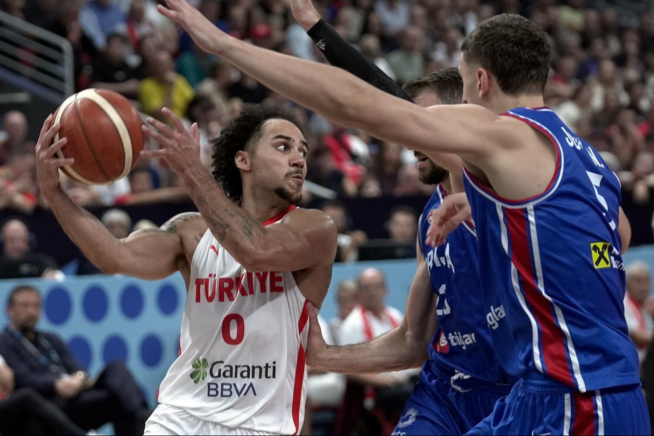 Türkiye’s Shane Larkin (0) in action against Serbia’s Marko Guduric (C) during the FIBA EuroBasket 2025 Group A match at Riga Arena in Riga, Latvia, on September 3, 2025. (AA Photo)