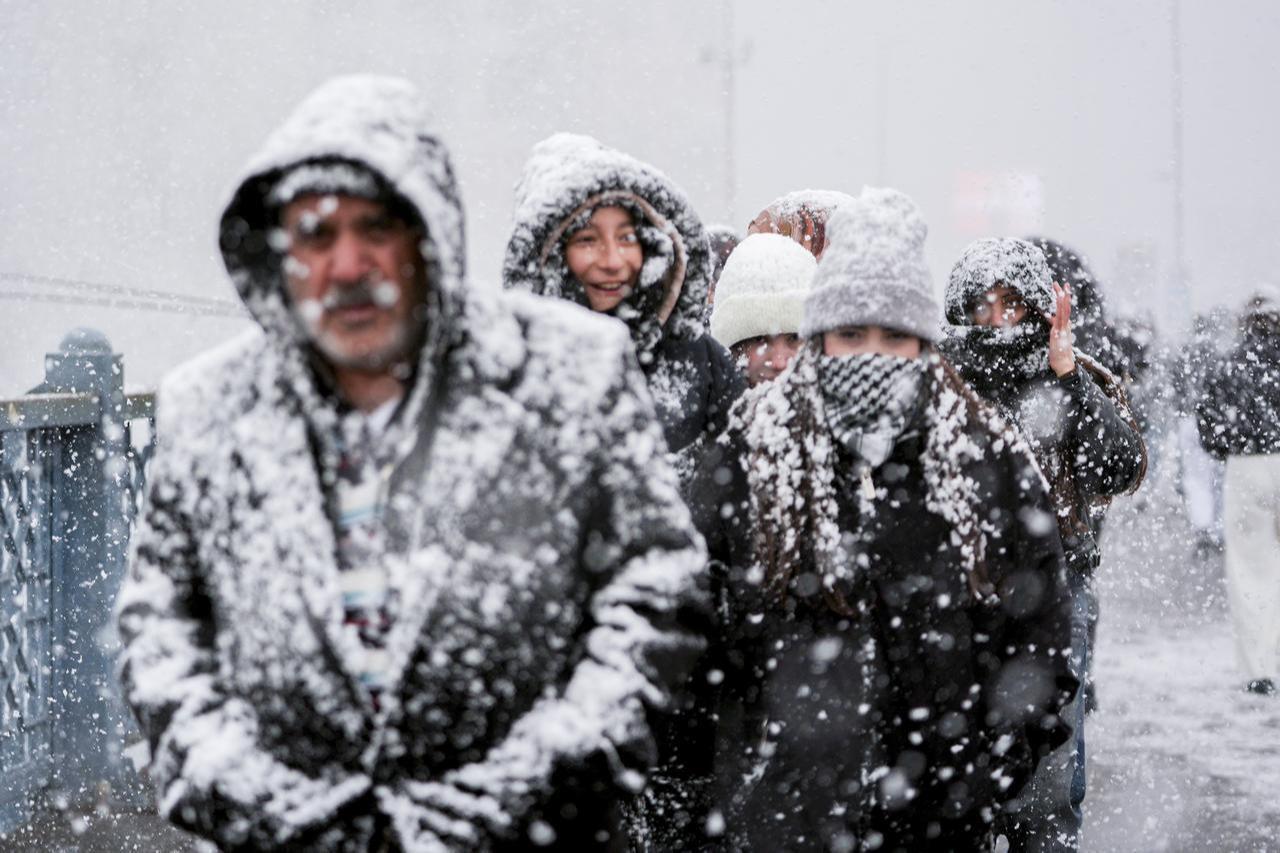 People are seen walking under heavy snowfall in the Eminonu area on Istanbul’s European side as snow continues to affect parts of the city during the first day of the New Year on Jan. 1, 2026. (AA Photo)