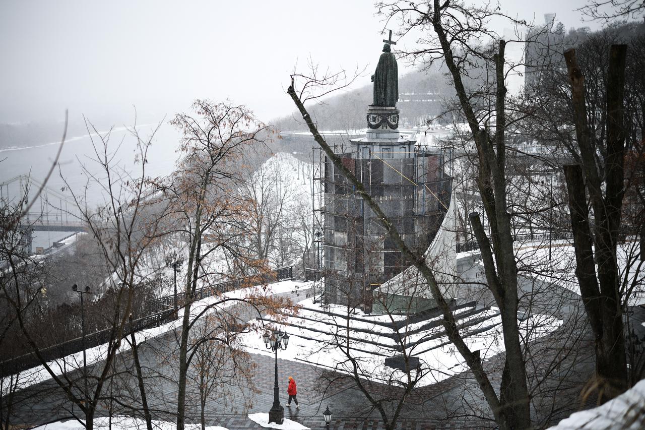 A pedestrian walks past the Volodymyr The Great Monument in Kyiv on February 25, 2026, amid the Russian invasion of Ukraine. (AFP Photo)
