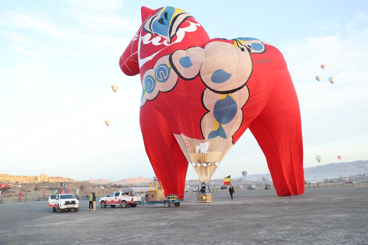 Hot air balloon rise over Cappadocia’s valleys near a large horse installation prepared for Chinese Year of the Horse celebrations, Nevsehir, Türkiye, Feb. 20, 2026. (AA Photo)