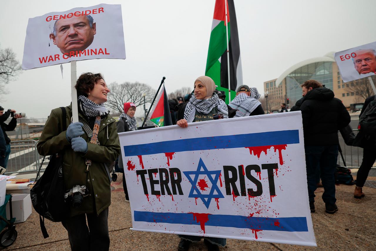 Anti-Trump and pro-Palestine protesters gather outside the Donald J. Trump Institute of Peace in Washington, DC on Feb. 19, 2026. (AFP Photo)